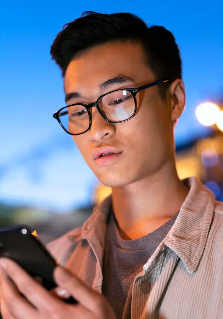 Student reviewing TalkCampus on their phone at night